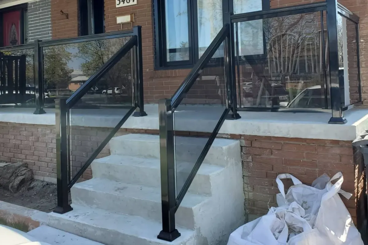 Black aluminum framed grey tinted glass railing in Ajax
