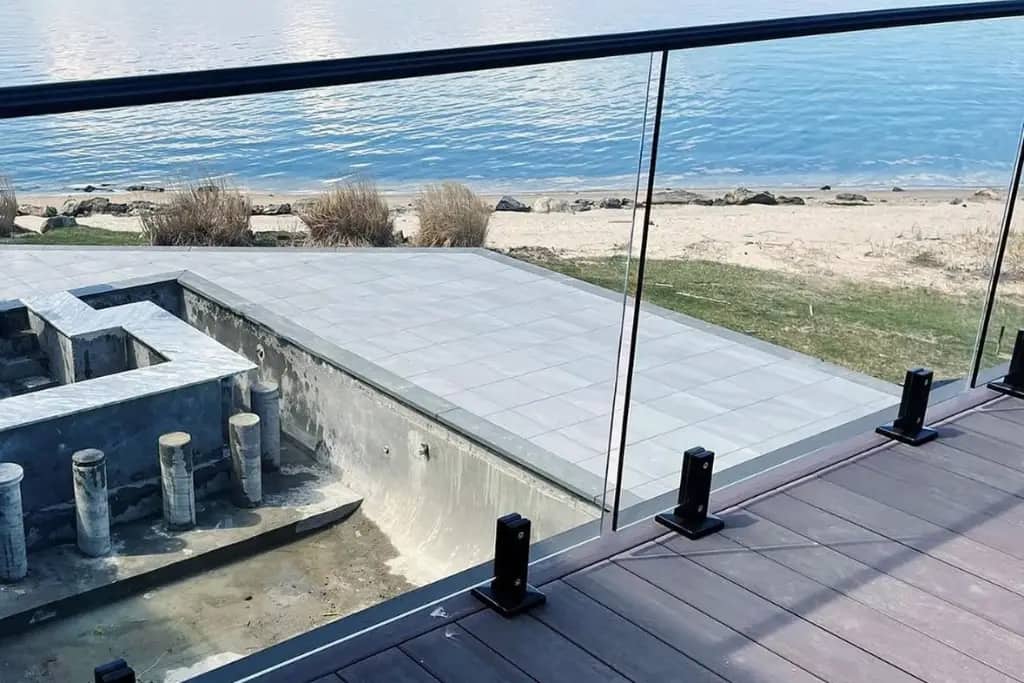 Frameless spigot glass railing on a composite deck overlooking the water at the Scarborough Bluffs