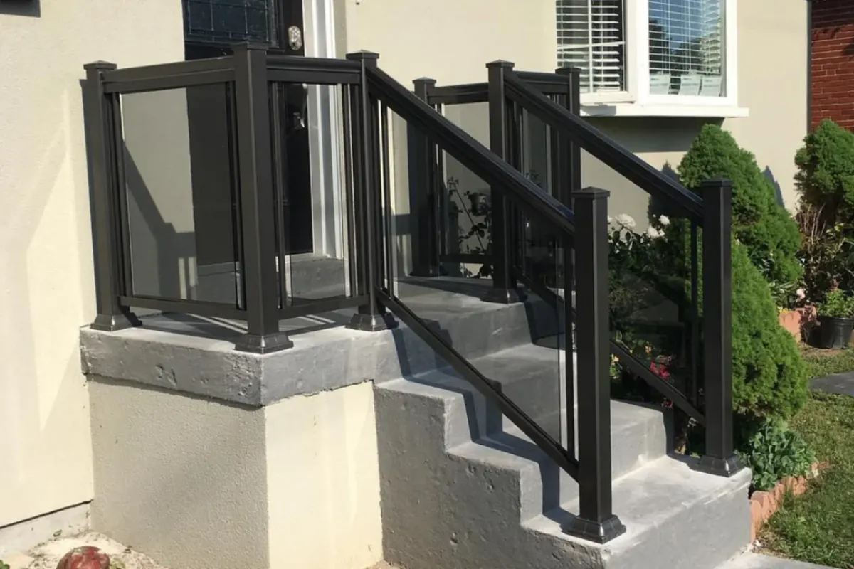 Black aluminum framed grey tinted glass railing in Pickering