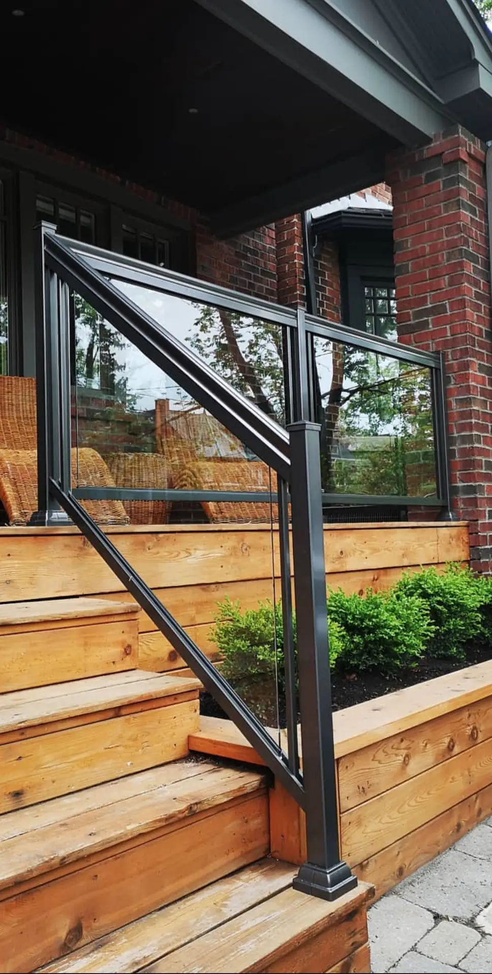 Black aluminum glass railing on a wood deck in The Beaches, Toronto